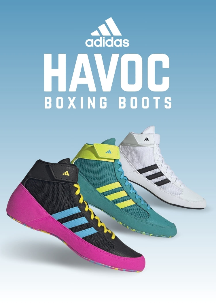 Adidas Havoc boxing boots in black, green, and white on a light blue background